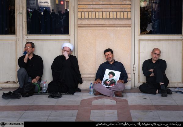 Family members seated outside the shrine