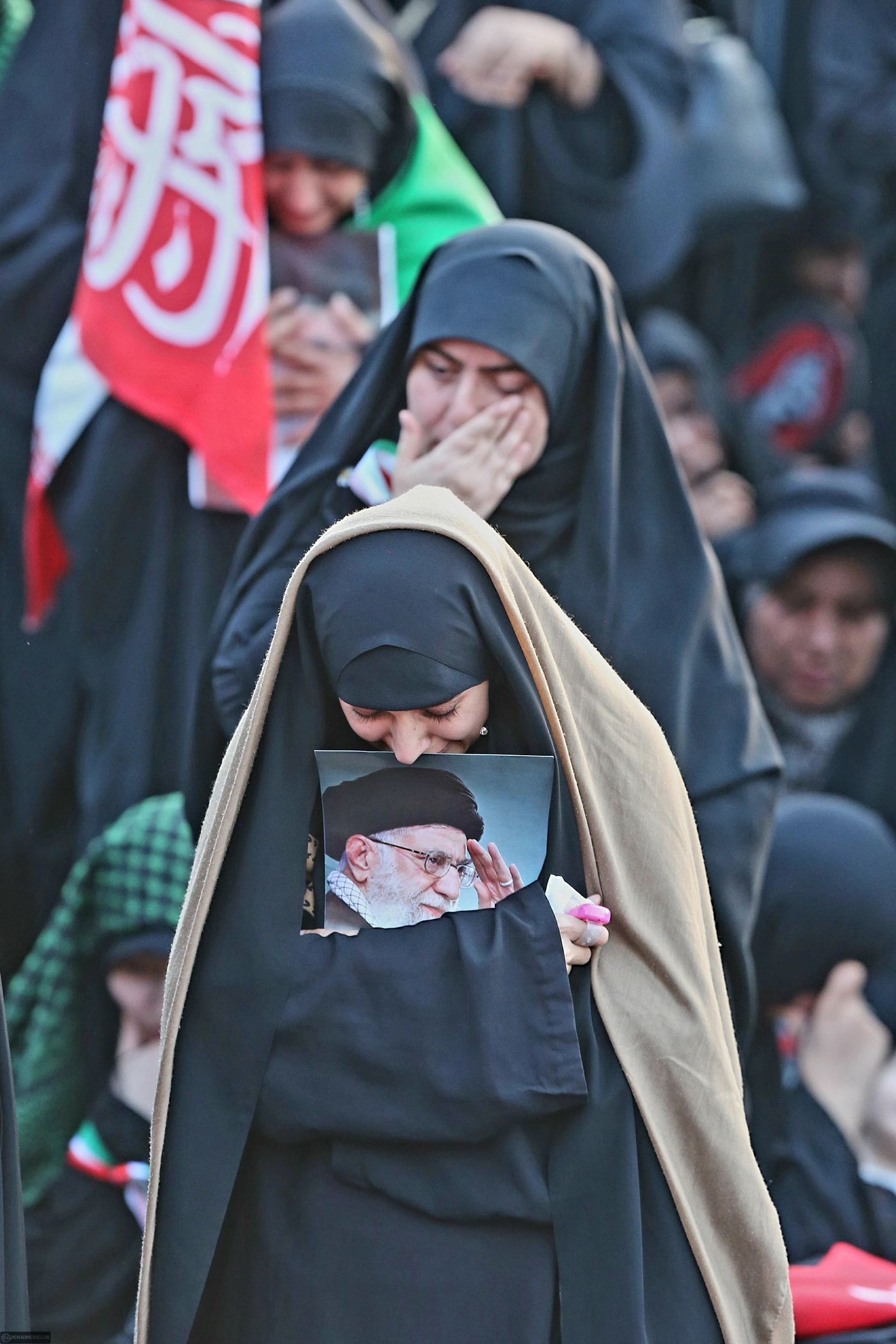 Woman mourner holding a portrait