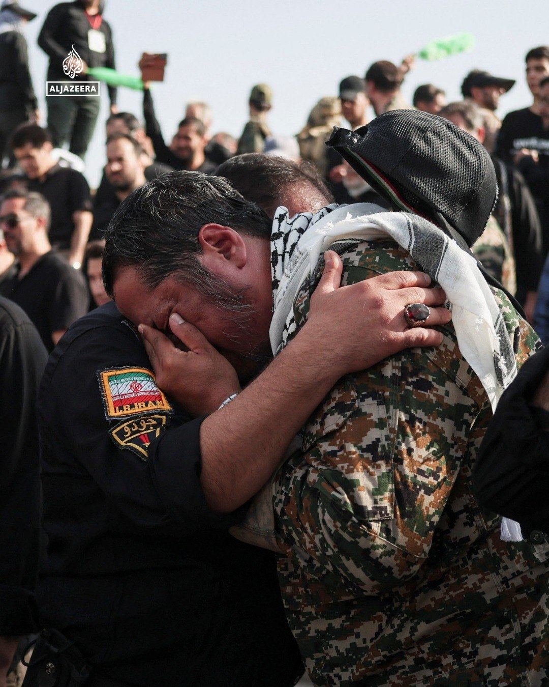 Two mourners embracing
