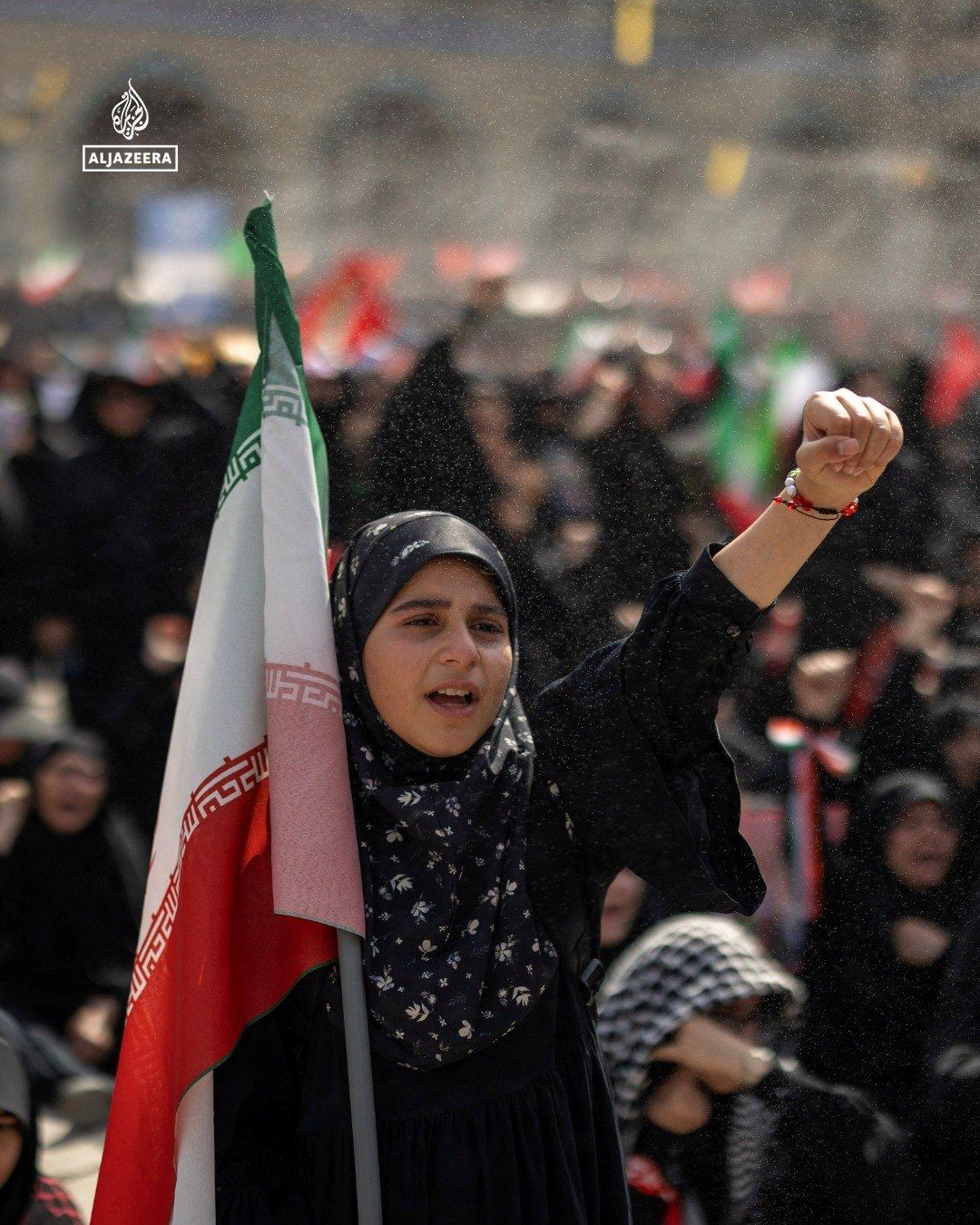 Woman raising her fist with a flag
